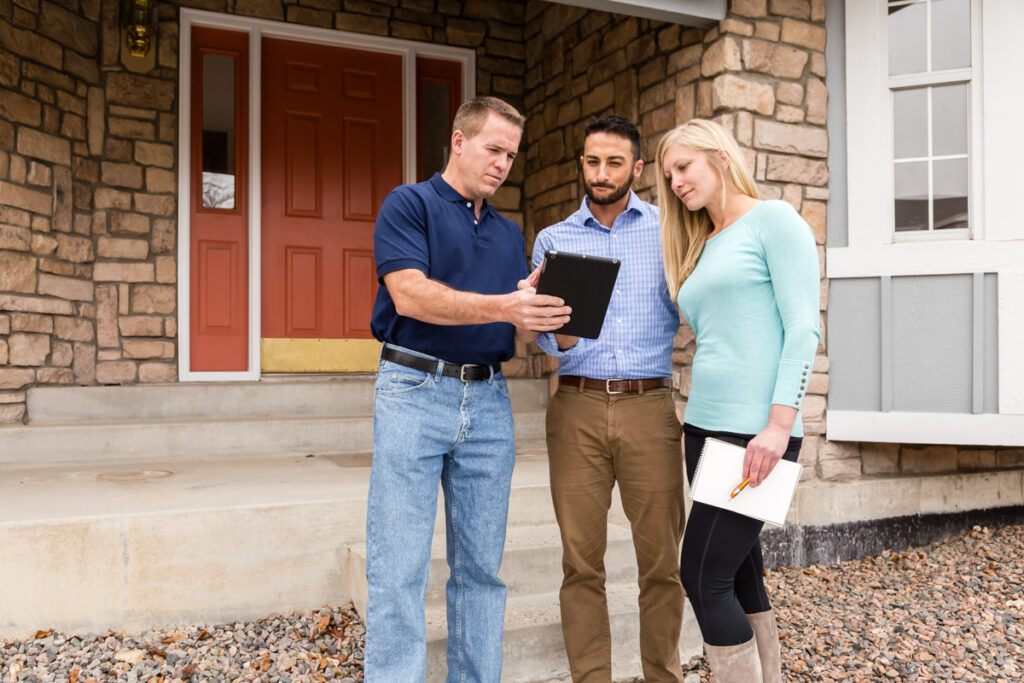 An inspector showing a report to a couple